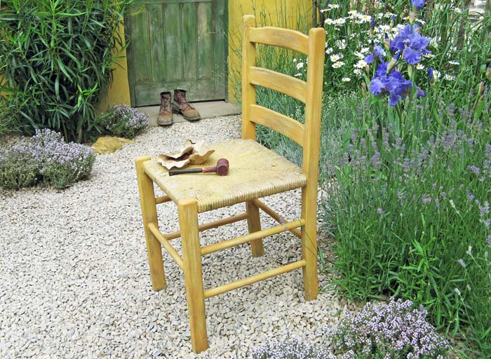 A photo of a chair with a pipe on it arranged in the style of one of Vincent Van Gogh's paintings