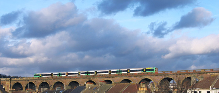 A viaduct takes a train above the rooftops