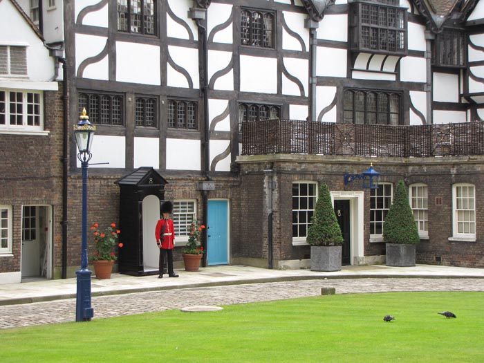 A guard stands outside the Queen's house in the tower of London